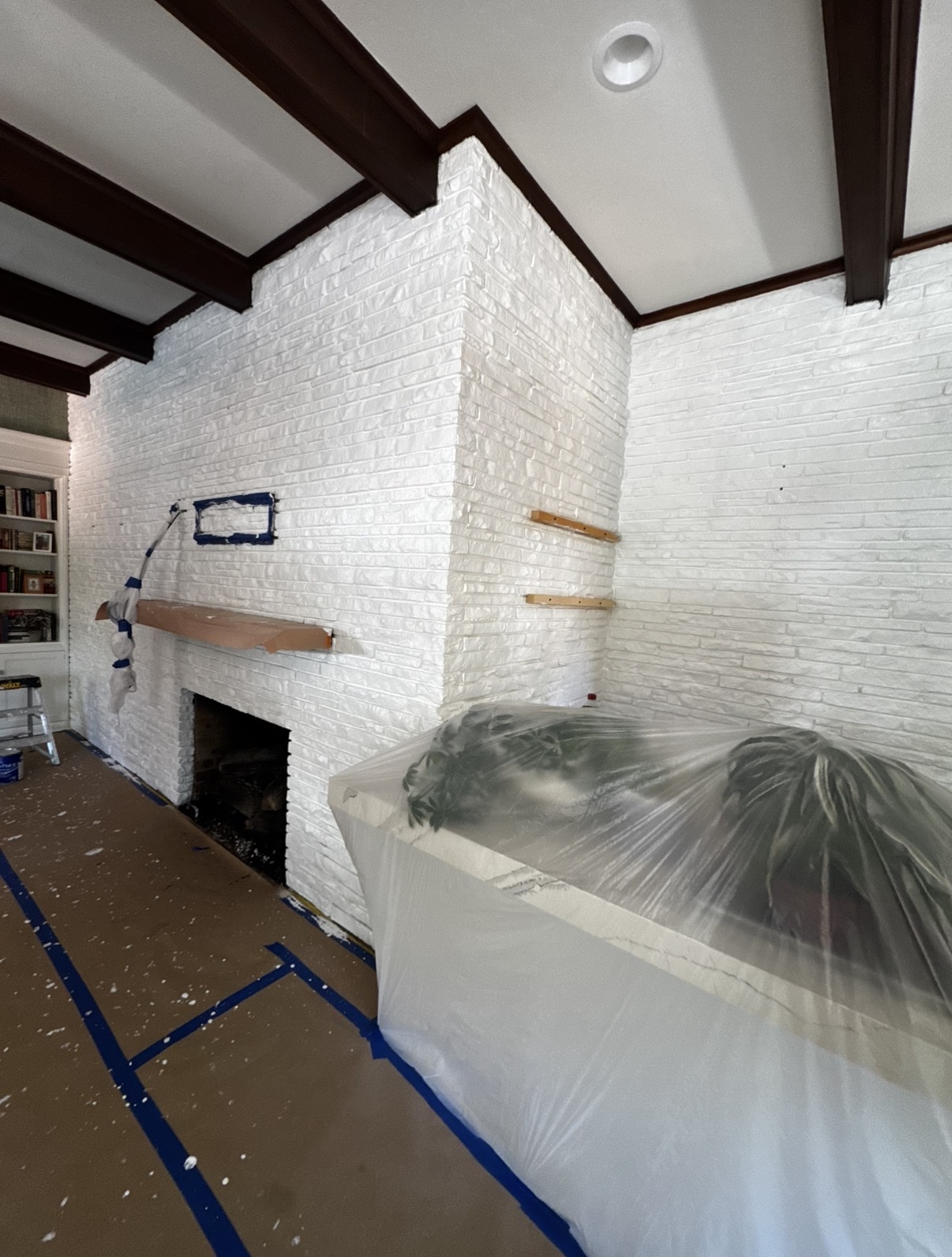 Completed white painted brick living room with dark beams