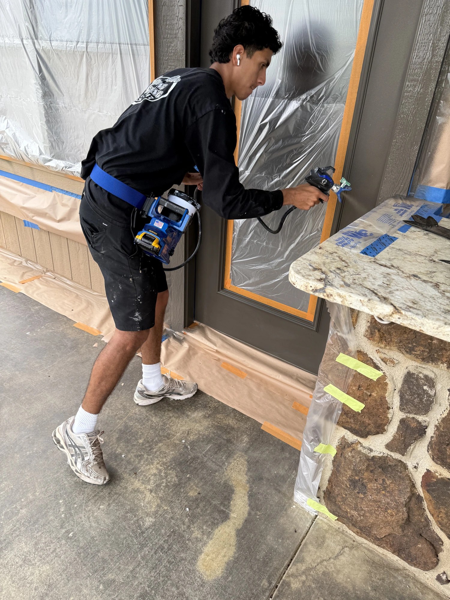 Spraying a smooth factory finish on an exterior door with everything masked off