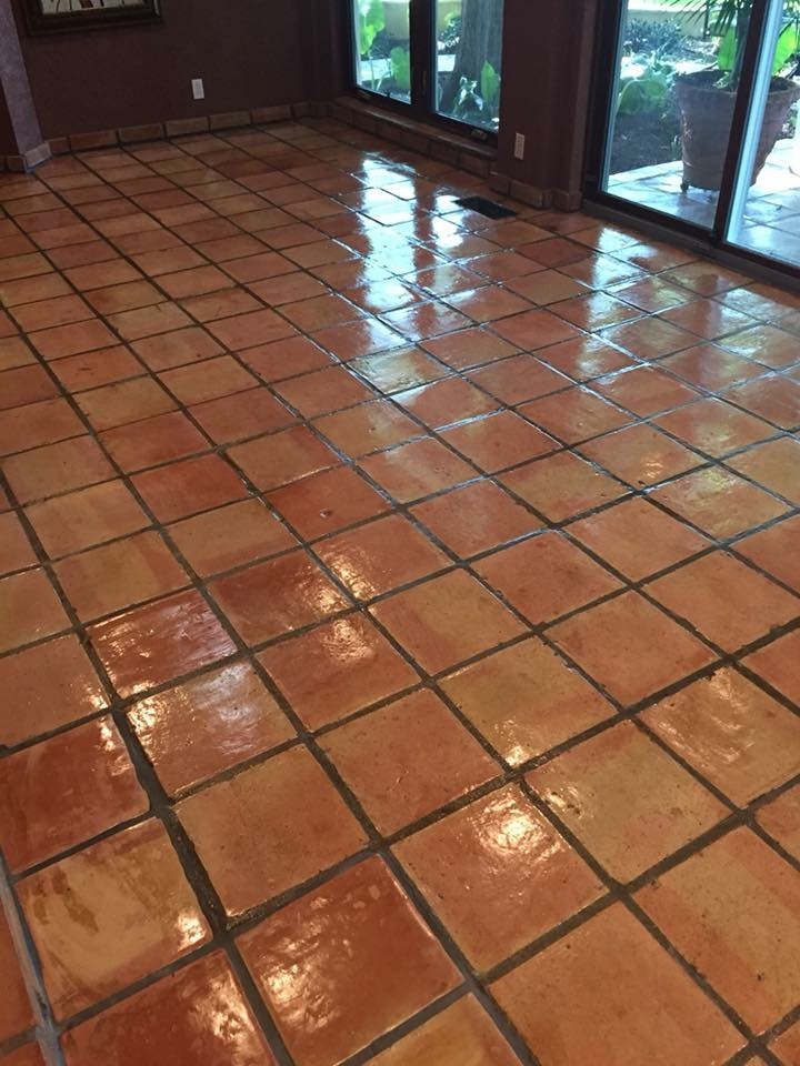 Glossy sealed Saltillo tile floor reflecting the windows