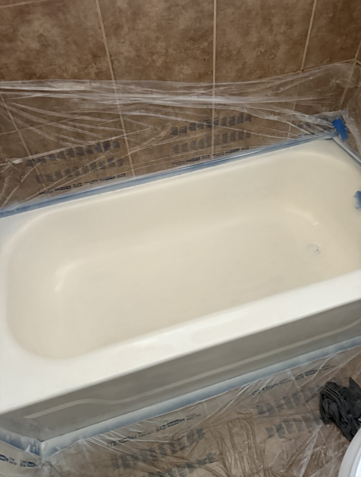 Glossy white bathtub after professional refinishing